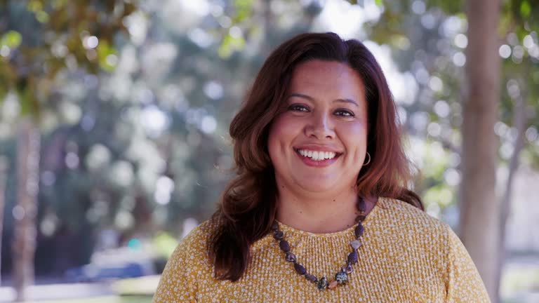 portrait of a beautiful mexican woman at a park